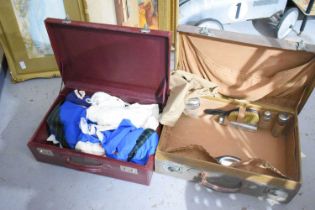 Two vintage suitcases, one in red leather with original outer cloth bag, and containing vintage