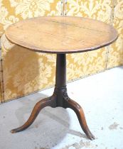 An 18th century oak side table with circular top and tripod base, 66cm diameter.