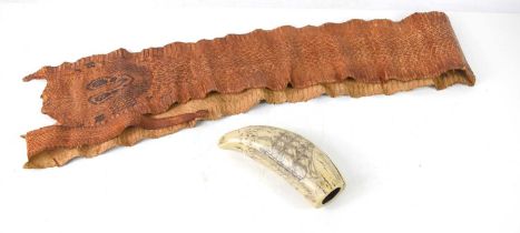 A large cobra snake skin measuring 168cm together with a reproduction scrimshaw whales tooth.
