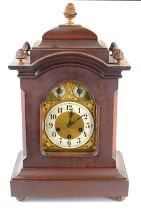 An early 20th century mahogany cased Junghans mantle clock, the dial with scroll spandrels and
