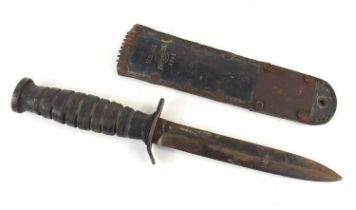 A WWII American US M3 knife, ordnance stamp to base of pommel with M6 scabbard marked Barwood 1943.