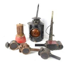 A group of vintage lamps and lanterns to include an Adlake Non-Sweating railway lamp.