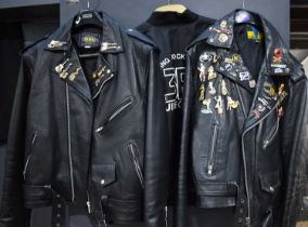 Two vintage leather motorcycle jackets, the jackets having various collectable badges on them to