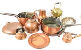A group of copper and brass ware to include 19th century copper and cast iron saucepans, brass