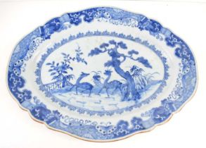 An 18th century Chinese porcelain blue and white plate, of oval shaped form, painted with a pair