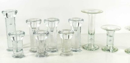 A group of Kosta Boda clear glass candlesticks, including seven pressed examples, and three with '