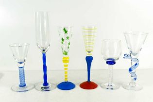 Two Anne Nilsson for Orrefors glass champagne flutes in the clown pattern, both initialled to the