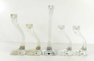Five Kosta Boda clear glass 'Connect' candlesticks, the tallest measures 25cm high.