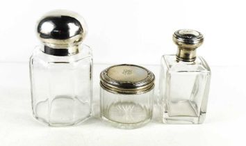 Three antique glass and silver topped dressing table bottles, two of the silver 800 grade tops