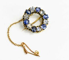 A Victorian sapphire and moonstone brooch of circular form, set with six cornflower blue sapphires