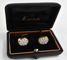 A pair of 18ct gold and diamond cufflinks by Kutchinsky, each of oval form, set with ten diamonds,