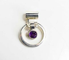 A silver and amethyst set pendant of circular form, with central suspended amethyst, length 34mm,