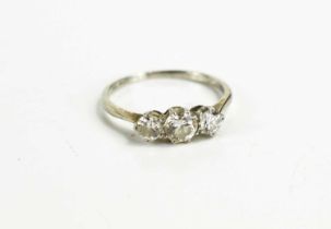 A diamond three stone ring, the central stone approximately 1/2ct, and 1/4ct either side, size N/
