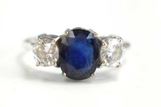 An 18ct white gold, diamond and sapphire three stone ring, each diamond of approximately 0.5ct, 4.