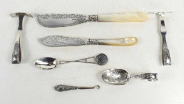 A group of silver to include two silver fish knives, two pushers, West Derby Golf Club spoon and