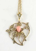 A 9ct gold Edwardian pendant of heart shaped form with lily to the centre, set with angel coral