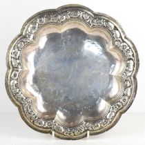 A Continental 800 grade silver shaped dish, the border repousse worked with flowers and the base