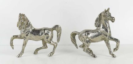 A pair of silver plated prancing horses.