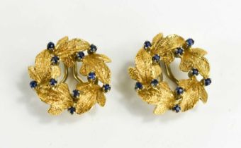 A pair of 18ct gold and sapphire clip on earrings, in the form of a wreath of leaves with