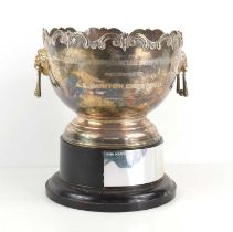 A silver twin handled trophy on a pedestal base, inscription to the front which reads "Wisbech