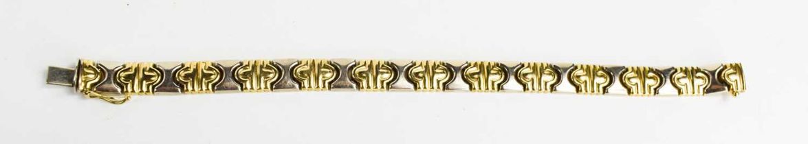 A bi-colour 9ct gold bracelet of abstracted 'x' and snaffle form, 19cm long, 14.97g.