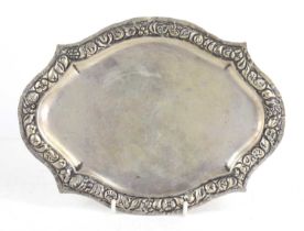 An antique white metal salver, the border relief decorated with flowers, 25cm by 19cm, stamped 800