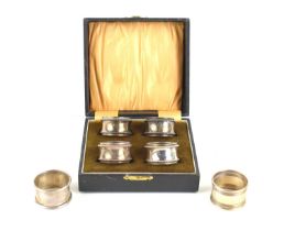 A cased set of four silver napkin rings, Birmingham 1926 together with two further silver napkin