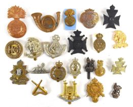 A group of military cap badges to include Kings Royal Rifle Corps, Loyal Suffolk Hussars, 1st