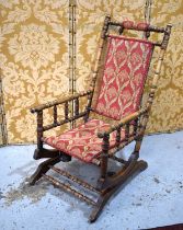 An early 20th century American rocking chair with spring mechanism and upholstered back and seat.