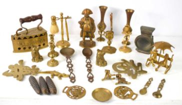 A group of brassware to include a shaving stand with razor and brush, a candle snuffer and holder,