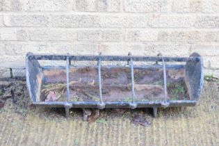 An iron pig trough, painted black, 79cm long by 30cm wide.