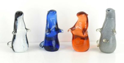 A group of four Wedgwood, Kings Lynn glass otter paperweights, designed by Ronald Stennett-Wilson