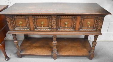 A 19th century Jacobean style oak sideboard, having three front carved legs, and two back with two