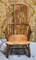 A 19th century Windsor armchair, the hoop back and bowed arm rail united by spindles and pierced