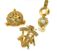 A brass nautical style compass together with a brass orienteering compass and a brass sextant.