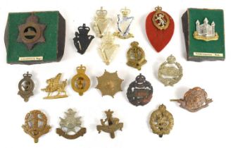 A group of military cap badges to include Shropshire Yeomanry, Notts & Derby, Royal Guernsey,