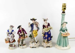 A pair of 19th century Sitzendorf porcelain figurines; woman with basket and gentleman with bird and