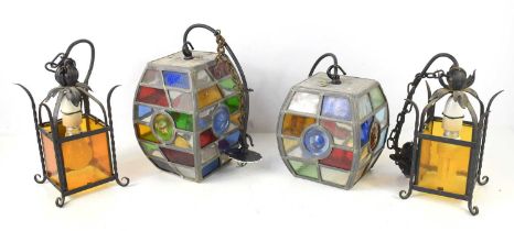 Two pairs of coloured hanging lamps, each of lantern form, the larger pair with coloured glass.