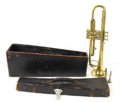 A vintage brass trumpet having mother of pearl panels to finger buttons inside a velvet lined