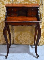 A reproduction mahogany ladies' writing desk on cabriole legs, the raised top fitted with four