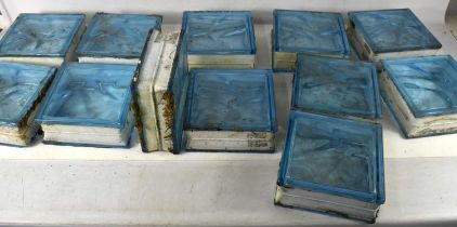 A group of twelve glass bricks, each of square form, triple glazed with sea blue glass, 19 by 19