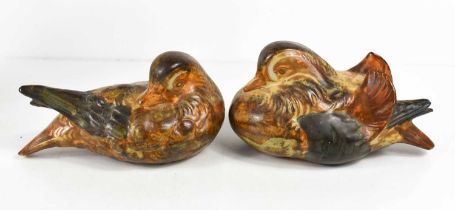 A pair of pottery ducks, glazed in muted tones, unsigned, 16cm long.