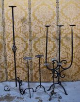 A selection of wrought iron pricket sticks to include a pair with knopped stems, two examples with