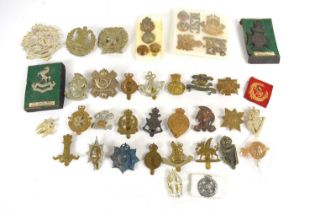 A group of regimental cap and collar badges and buttons, including the 2nd Volunteer Highland