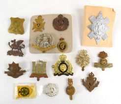 A group of military cap badges to include the Worcestershire regiment, Royal Engineers, Volunteer