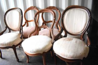 A group of Victorian balloon back chairs, some with carved backs, in cream and pink fabrics.