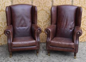 A pair of brown leather wingback armchairs with studded detailing,made bespoke by IPEC, 113cm high