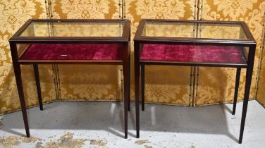 A pair of mahogany vitrines or display tables, having hinged, lockable lids, burgundy velvet