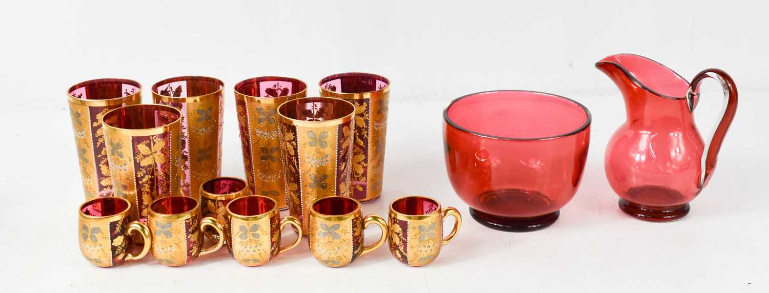A group of Bohemian cranberry glass beakers, small cups, jug and bowl.