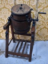 A Braeford Patent revolving butter churn on stand, the coopered barrel having casto iron mounts